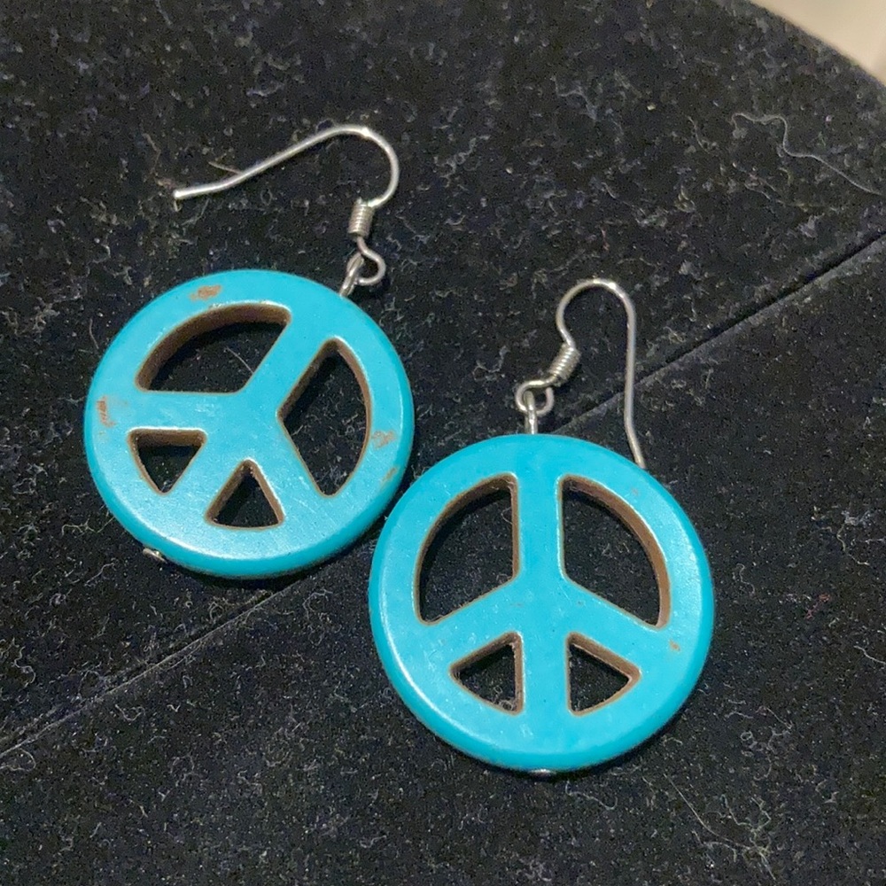 A pair of pierced ceramic Earrings, w/ peace sign